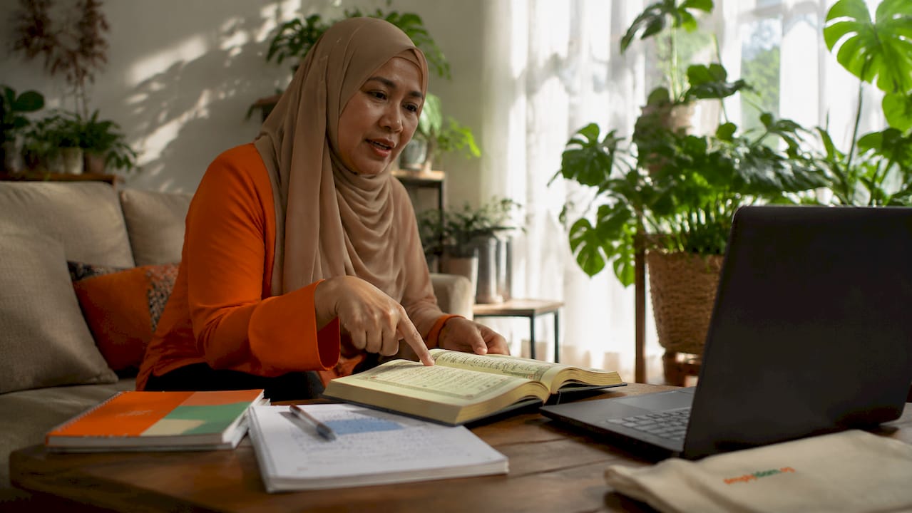 Female Quran teacher conducting online lesson