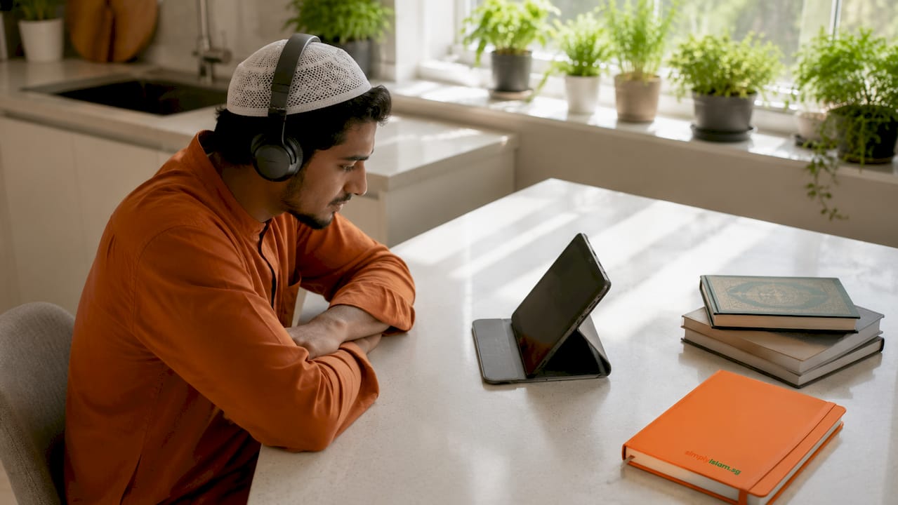 Man listening to recorded Islamic lecture at home